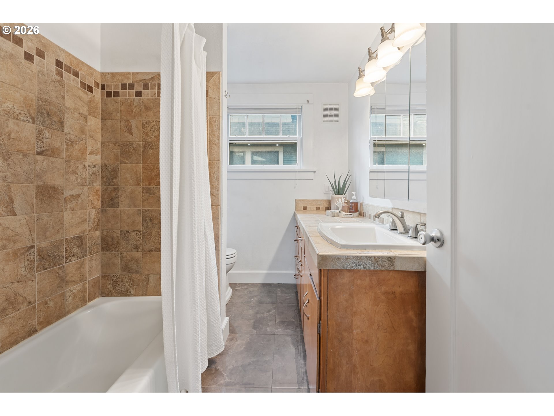 2845 Northeast 53rd Avenue Portland, OR 97213 - Photo 20 of 29 a bathroom with a sink a mirror and a shower