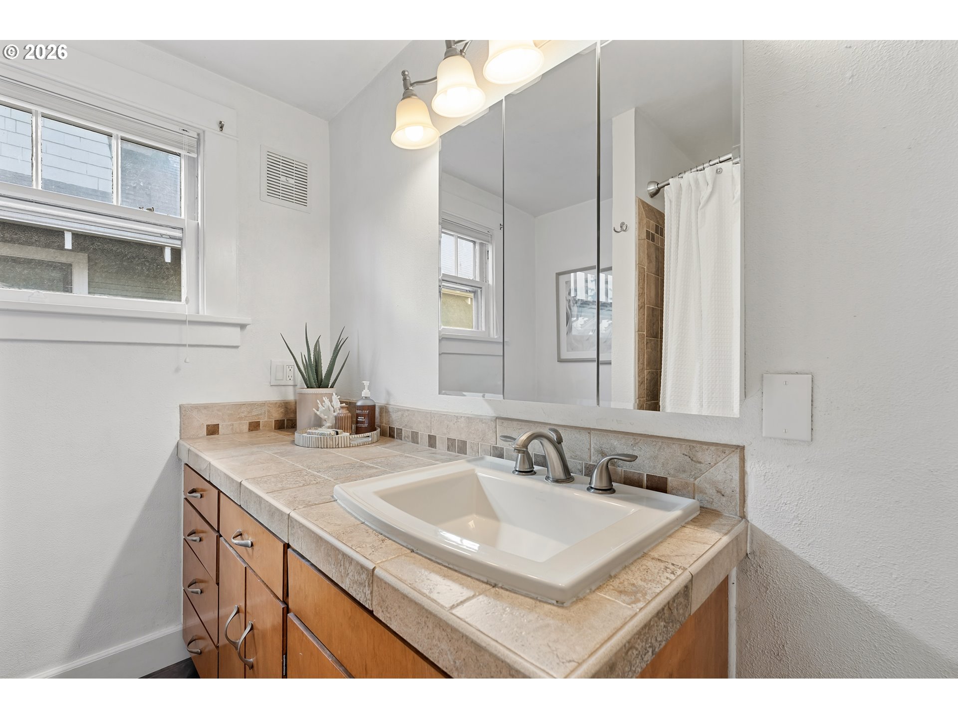 2845 Northeast 53rd Avenue Portland, OR 97213 - Photo 21 of 29 a bathroom with a sink vanity granite and a mirror