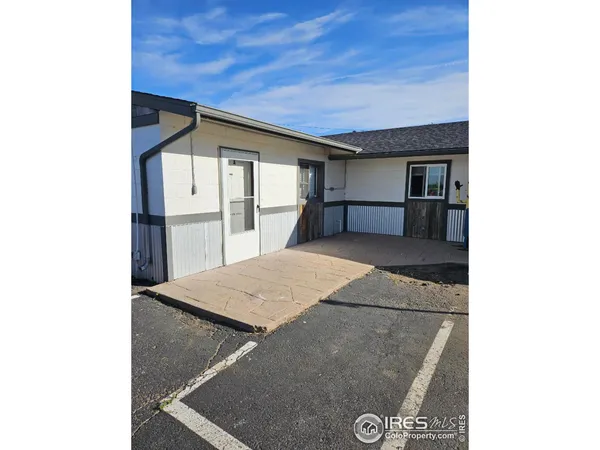 a kitchen with a refrigerator and white cabinets
