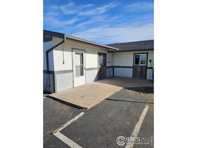 a kitchen with a refrigerator and white cabinets
