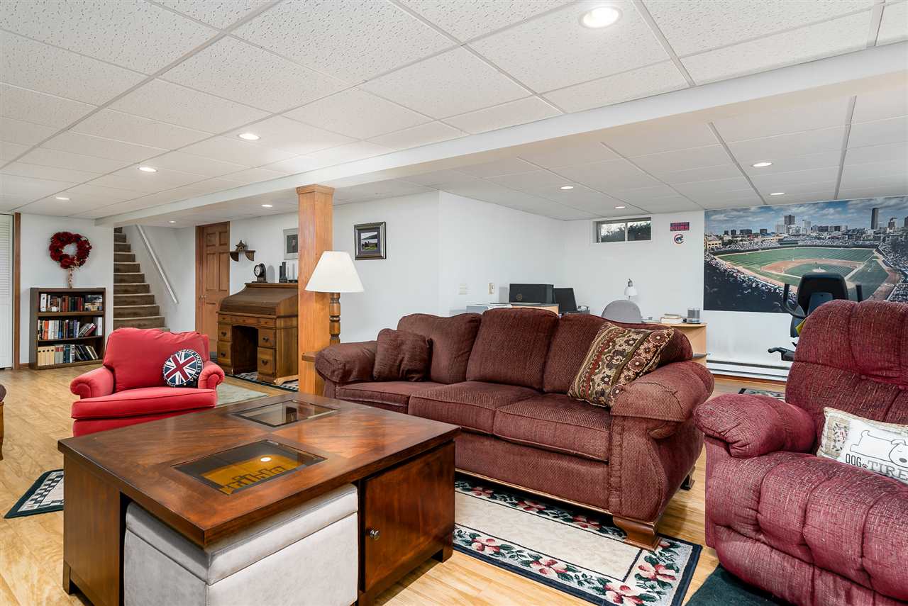 3310 East Whitaker Road Byron, IL 61010 - Photo 14 of 25 a living room with furniture a fireplace and a flat screen tv