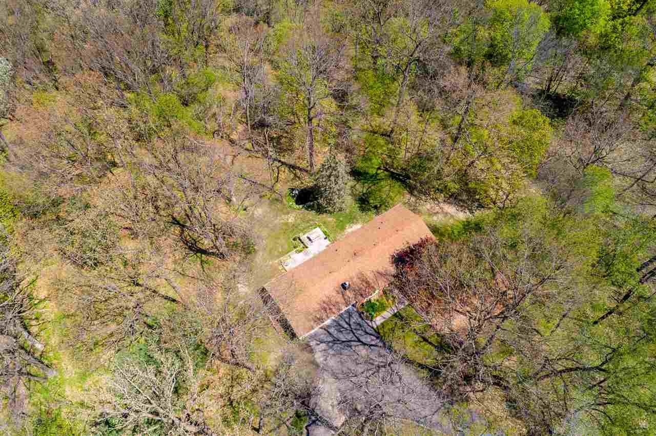 3310 East Whitaker Road Byron, IL 61010 - Photo 16 of 25 a view of a yard with plants and large trees