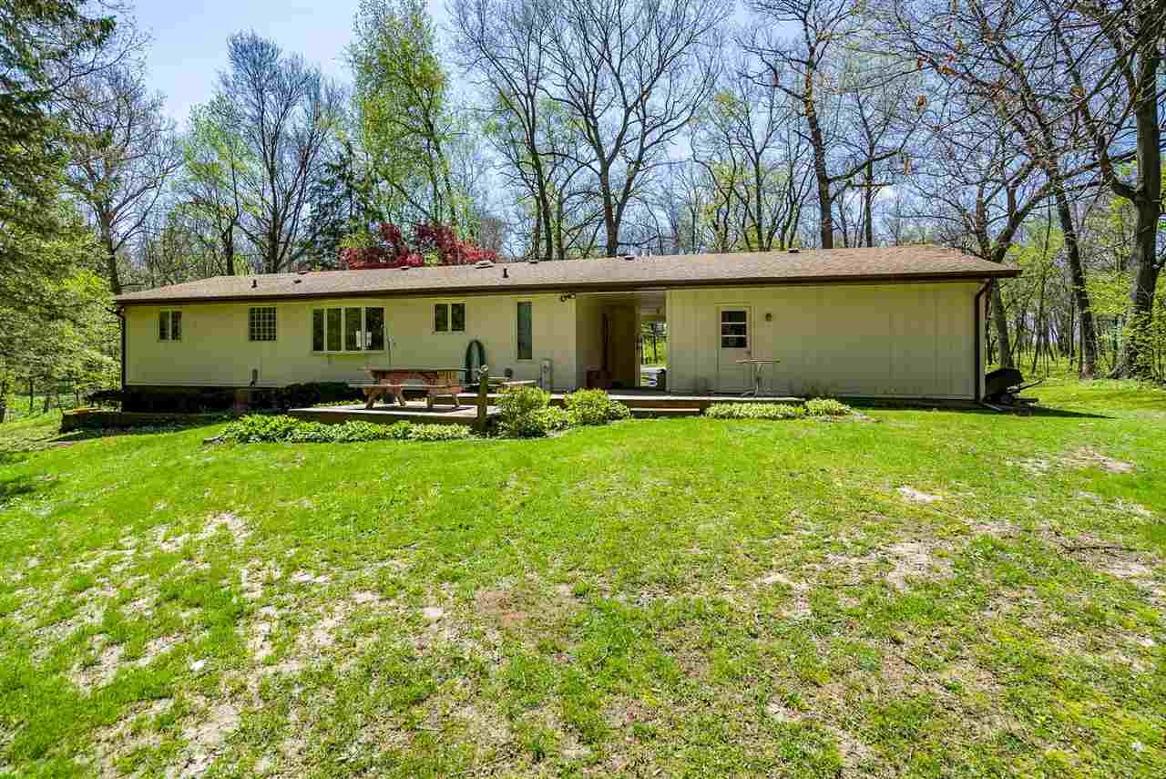 3310 East Whitaker Road Byron, IL 61010 - Photo 19 of 25 a front view of a house with a yard and trees