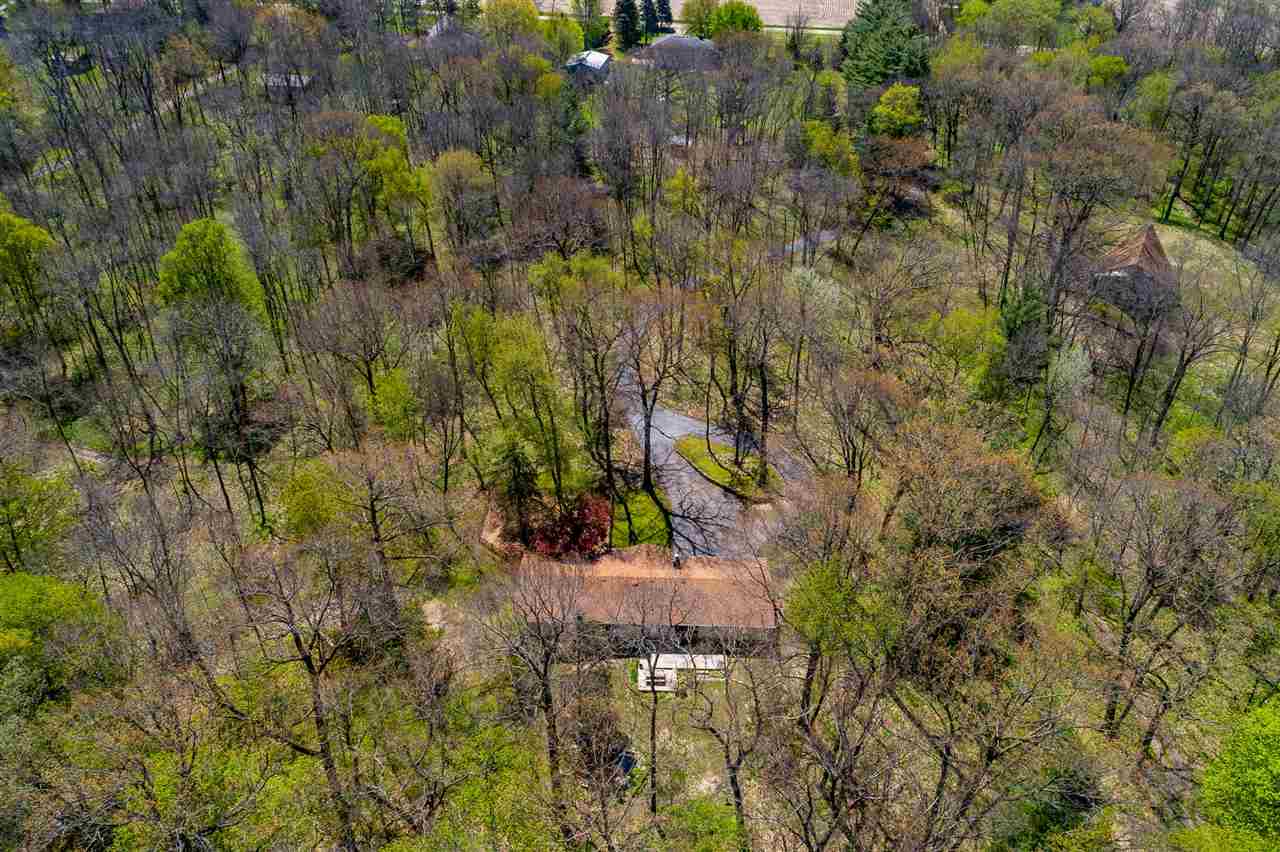 3310 East Whitaker Road Byron, IL 61010 - Photo 2 of 25 a backyard of a house with lots of trees