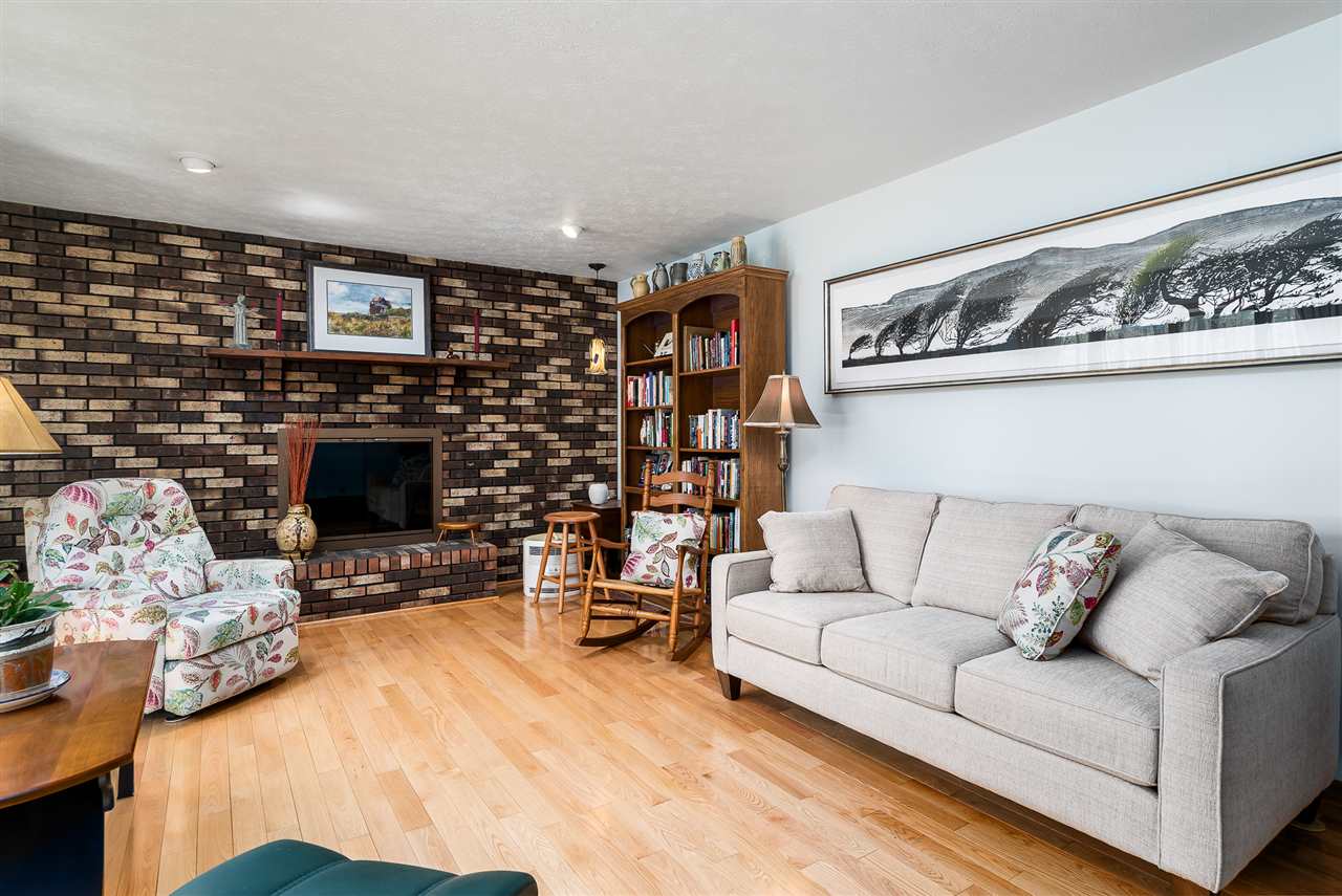 3310 East Whitaker Road Byron, IL 61010 - Photo 3 of 25 a living room with furniture a flat screen tv and a fireplace