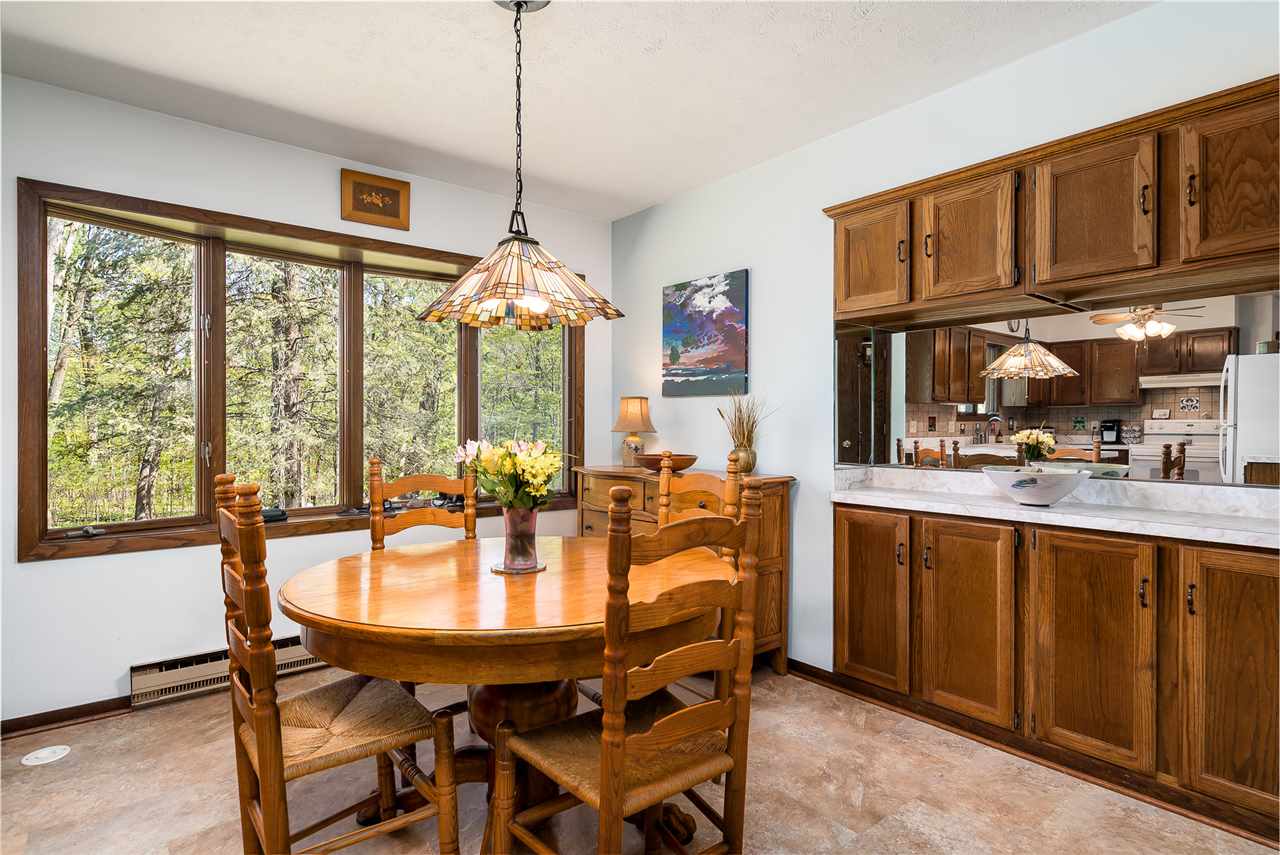 3310 East Whitaker Road Byron, IL 61010 - Photo 6 of 25 a view of a dining room and livingroom with furniture wooden floor a chandelier