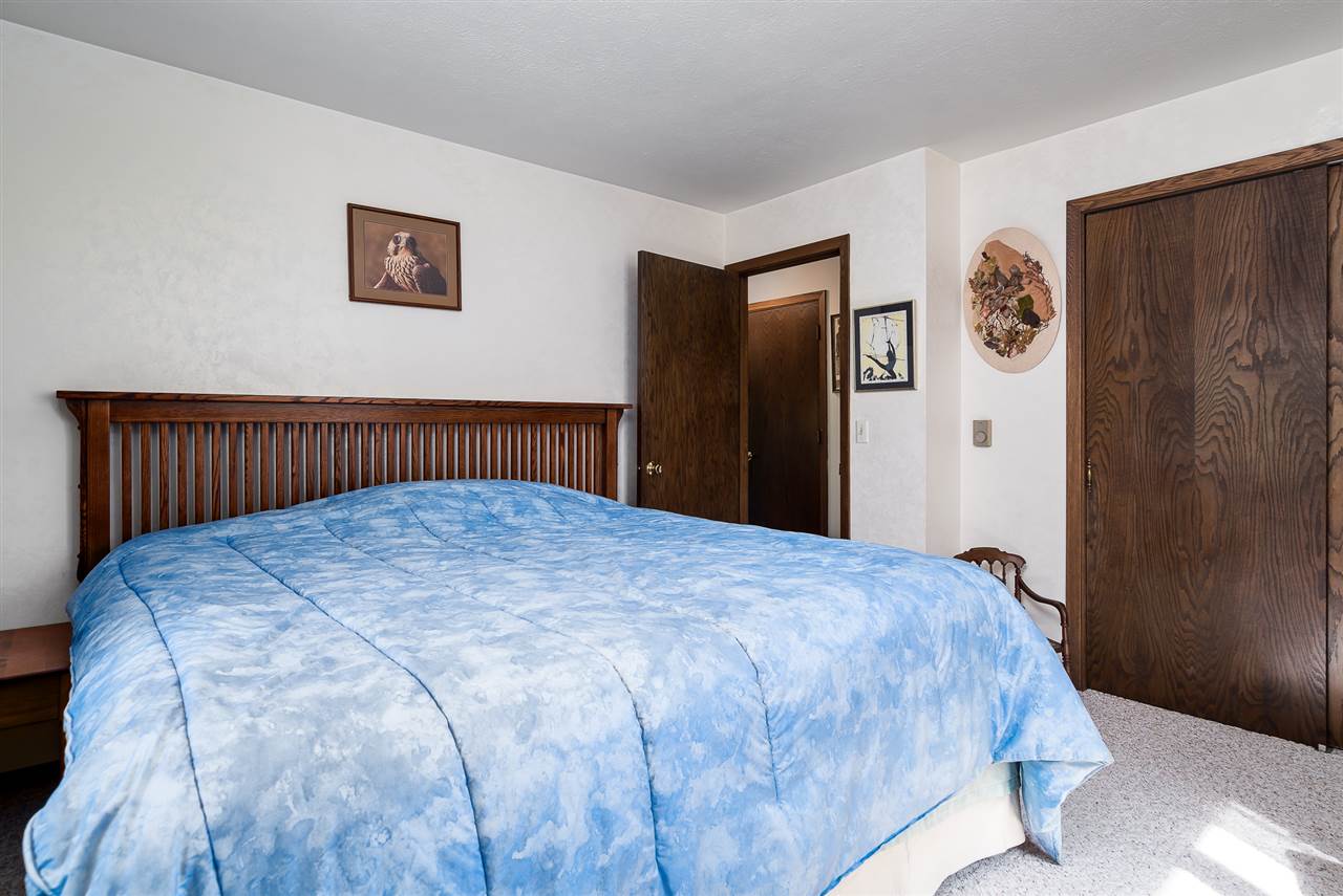 3310 East Whitaker Road Byron, IL 61010 - Photo 9 of 25 a bedroom with a bed and painting on the wall