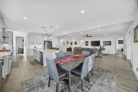 a large kitchen with a table and chairs