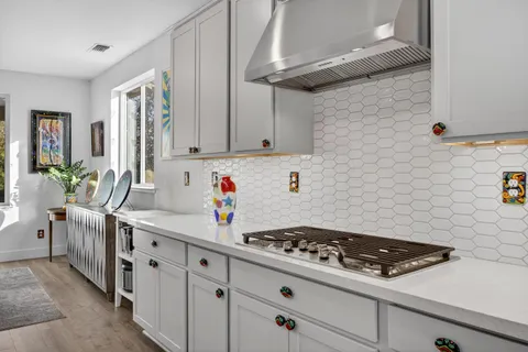 a kitchen with stainless steel appliances a stove microwave and a refrigerator