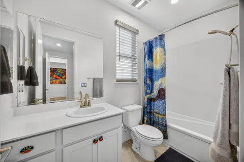 a bedroom with furniture and a large window