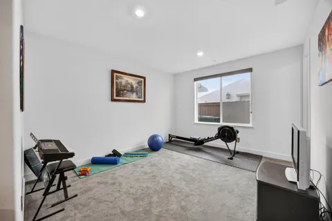 a bedroom with a bed and a large window
