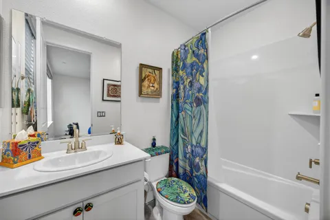 a bathroom with a tub a sink and mirror