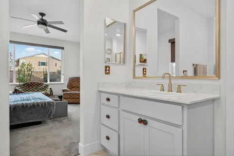 a living room with patio furniture and a garden
