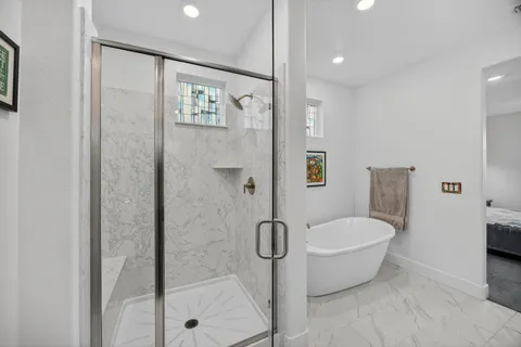 a living room with patio furniture and a floor to ceiling window
