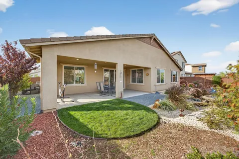 an aerial view of a house with garden space and sitting area