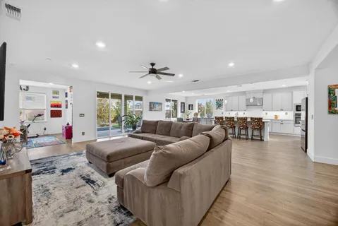 a living room with furniture and wooden floor