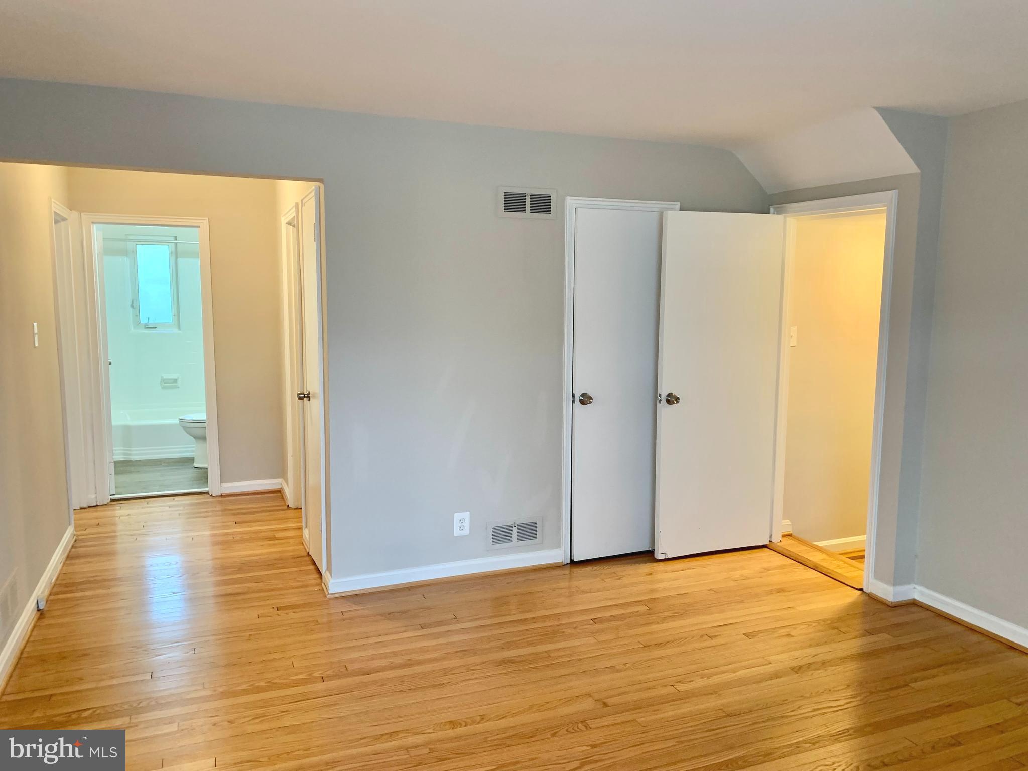 2615 13th Road South Arlington, VA 22204 - Photo 13 of 41 a view of an empty room with wooden floor and a window