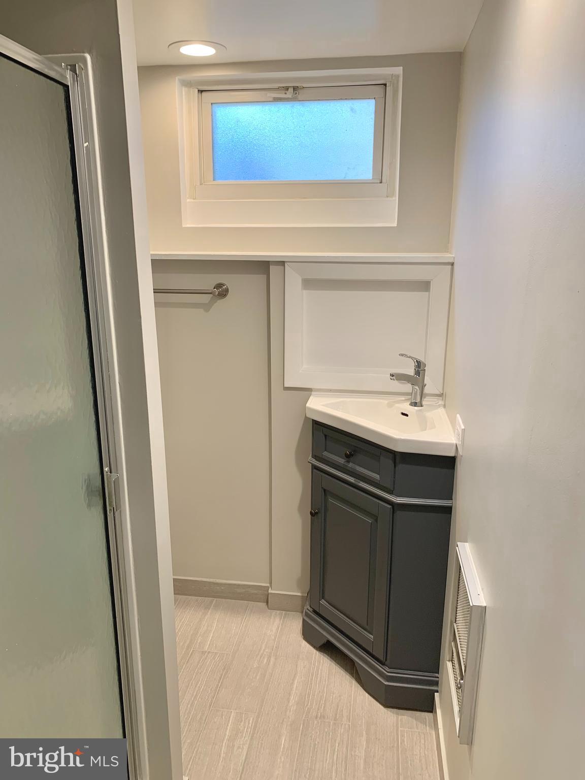 2615 13th Road South Arlington, VA 22204 - Photo 25 of 41 a bathroom with a sink and a mirror