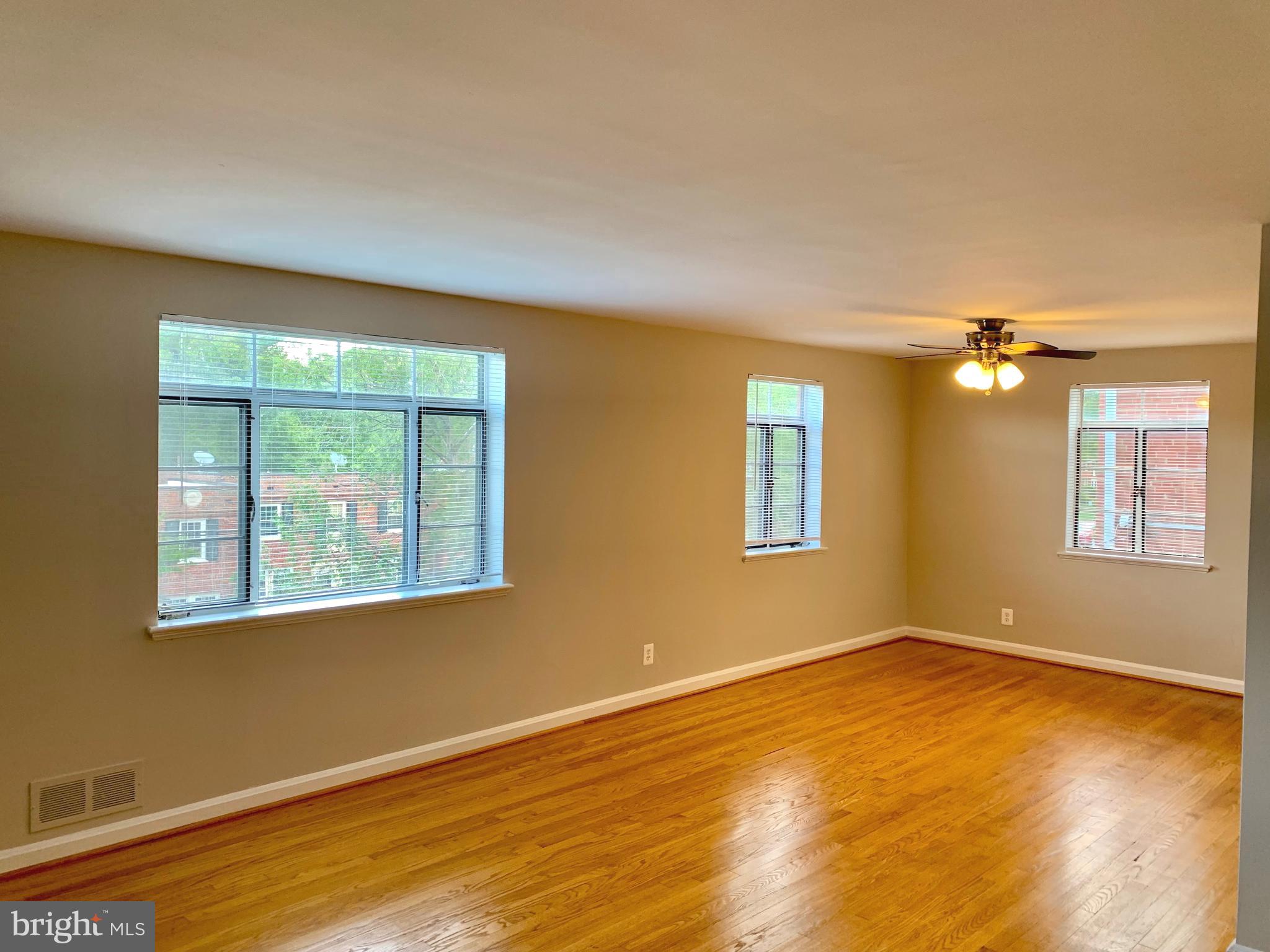 2615 13th Road South Arlington, VA 22204 - Photo 4 of 41 a view of an empty room with wooden floor and a window
