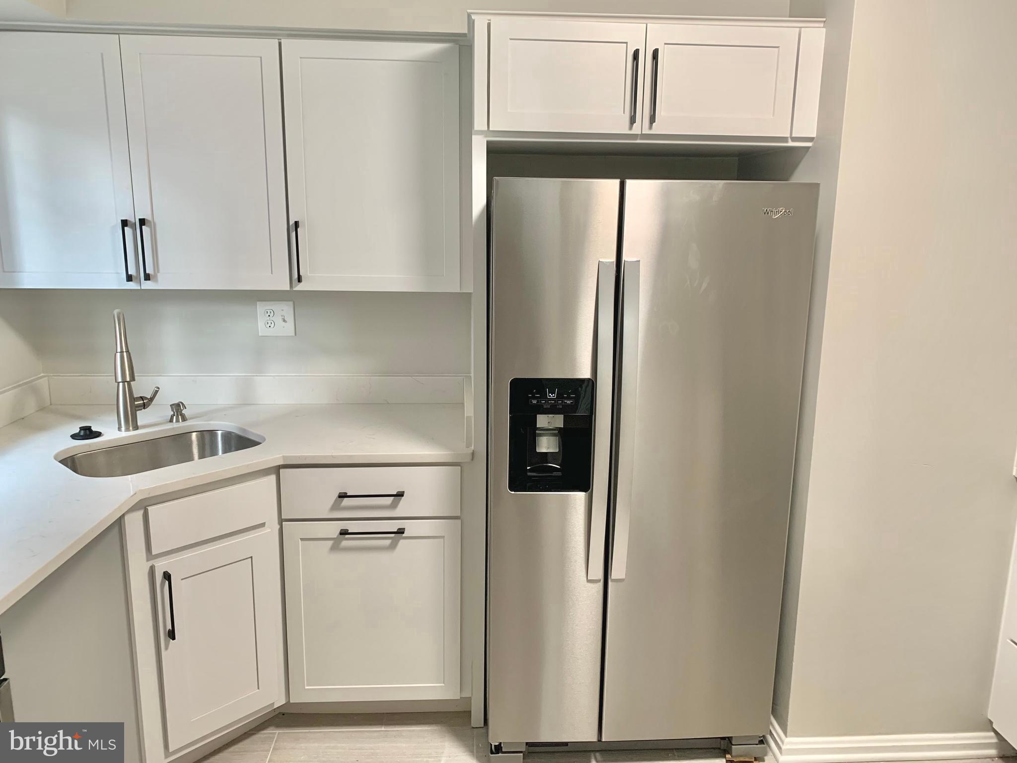 2615 13th Road South Arlington, VA 22204 - Photo 7 of 41 a kitchen with a refrigerator sink and cabinets