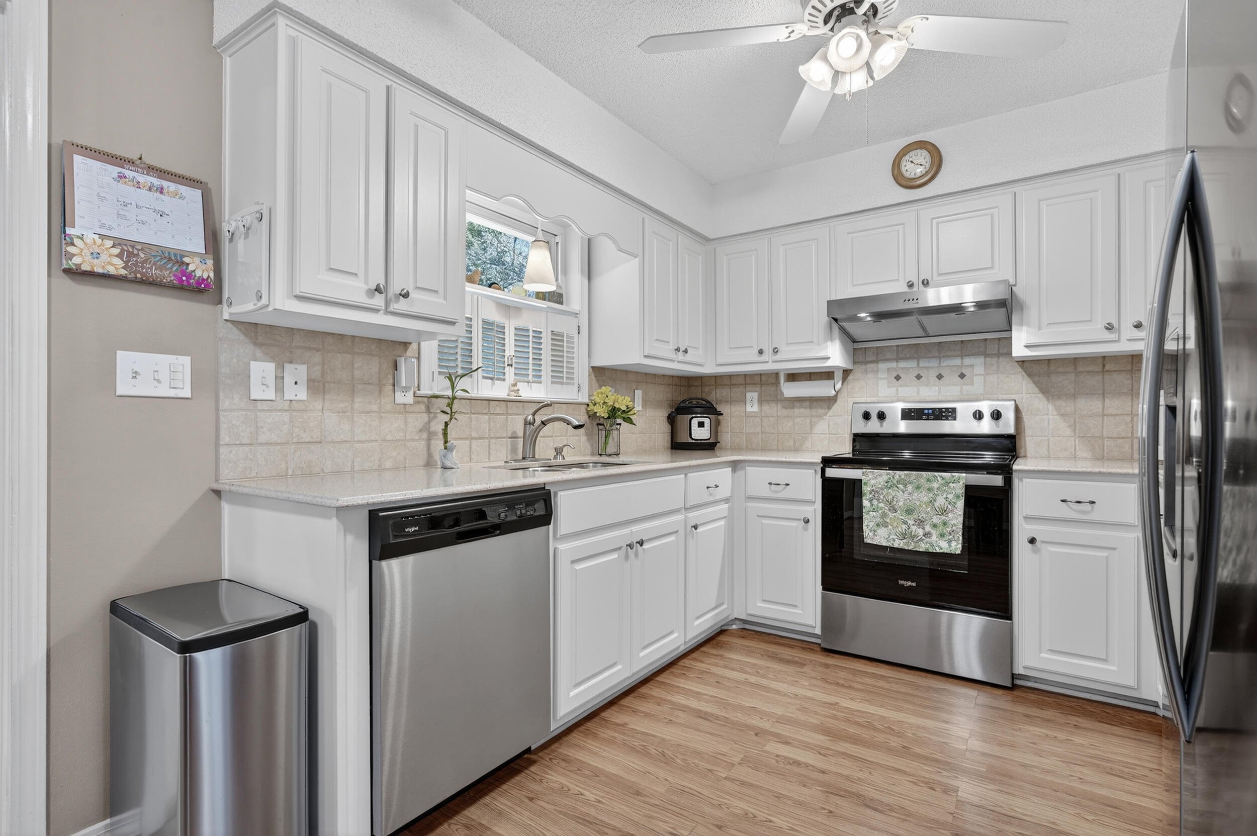 105 Cedar Point Road Crestview, FL 32539 - Photo 24 of 53 a kitchen with granite countertop a refrigerator stove and white cabinets