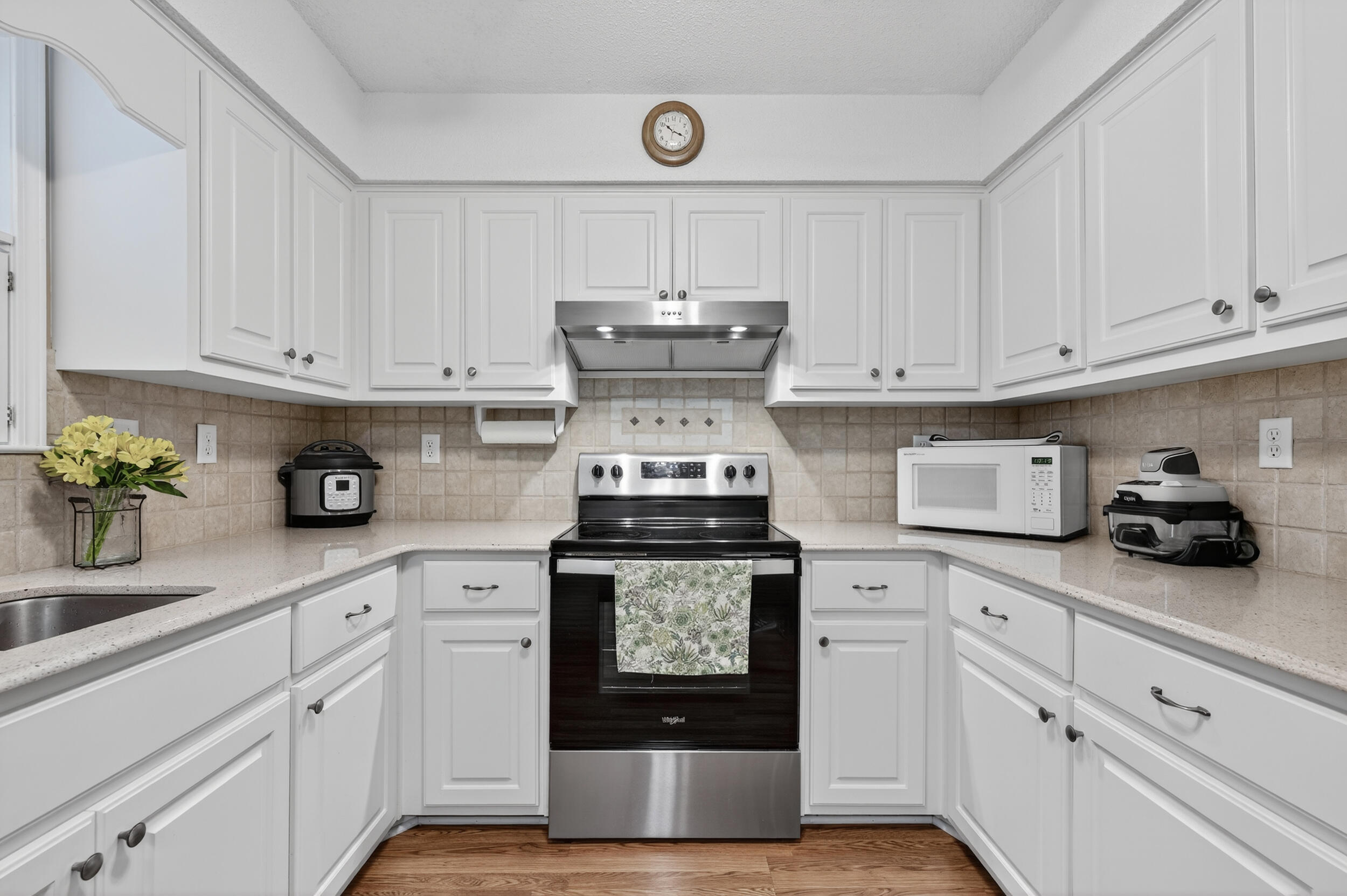 105 Cedar Point Road Crestview, FL 32539 - Photo 25 of 53 a kitchen with granite countertop white cabinets and stainless steel appliances