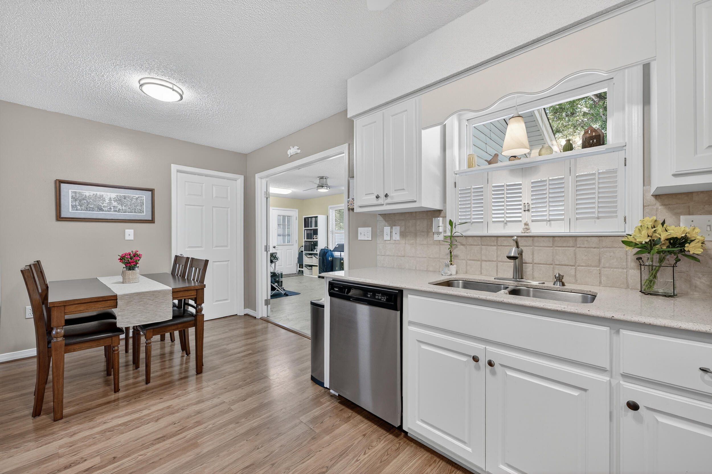 105 Cedar Point Road Crestview, FL 32539 - Photo 27 of 53 a kitchen with a sink cabinets and wooden floor
