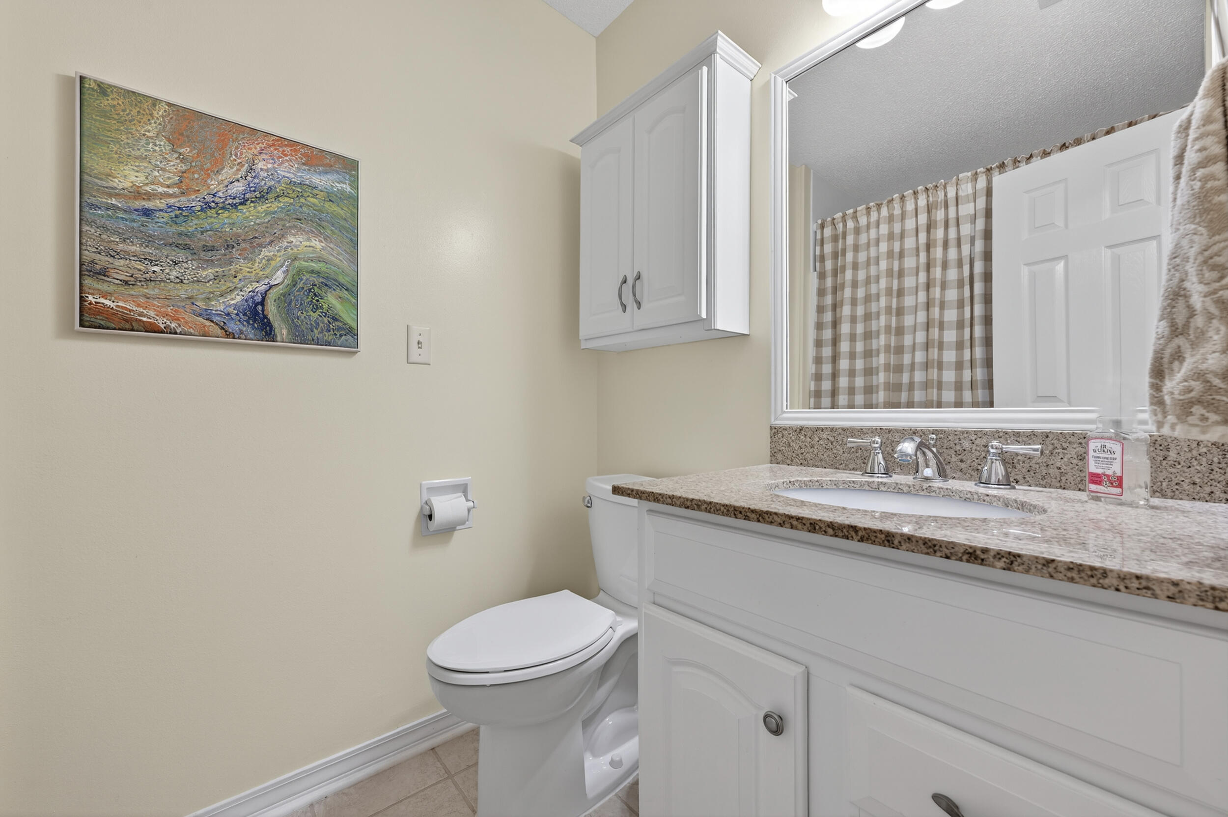 105 Cedar Point Road Crestview, FL 32539 - Photo 37 of 53 a bathroom with a granite countertop sink mirror vanity and toilet