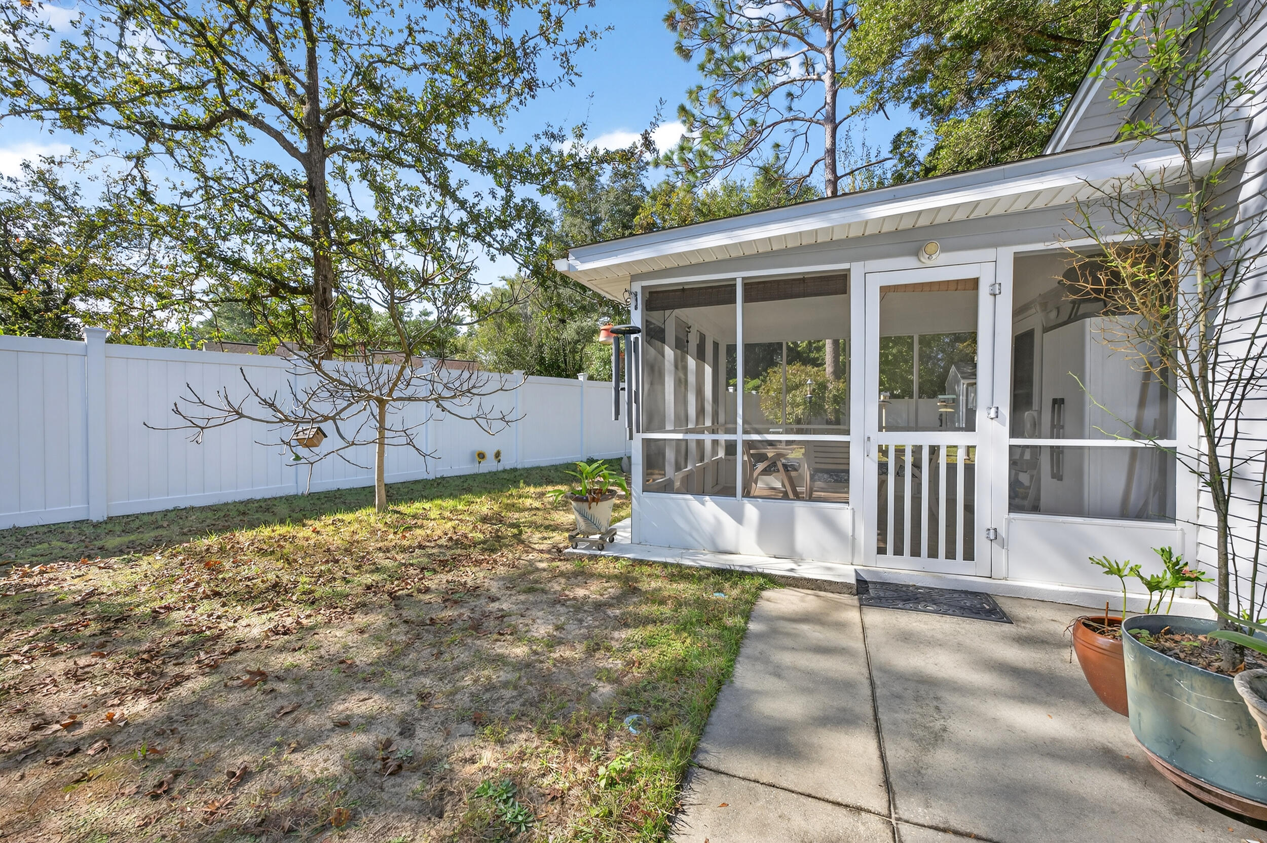 105 Cedar Point Road Crestview, FL 32539 - Photo 41 of 53 a view of a house with a small yard and large tree