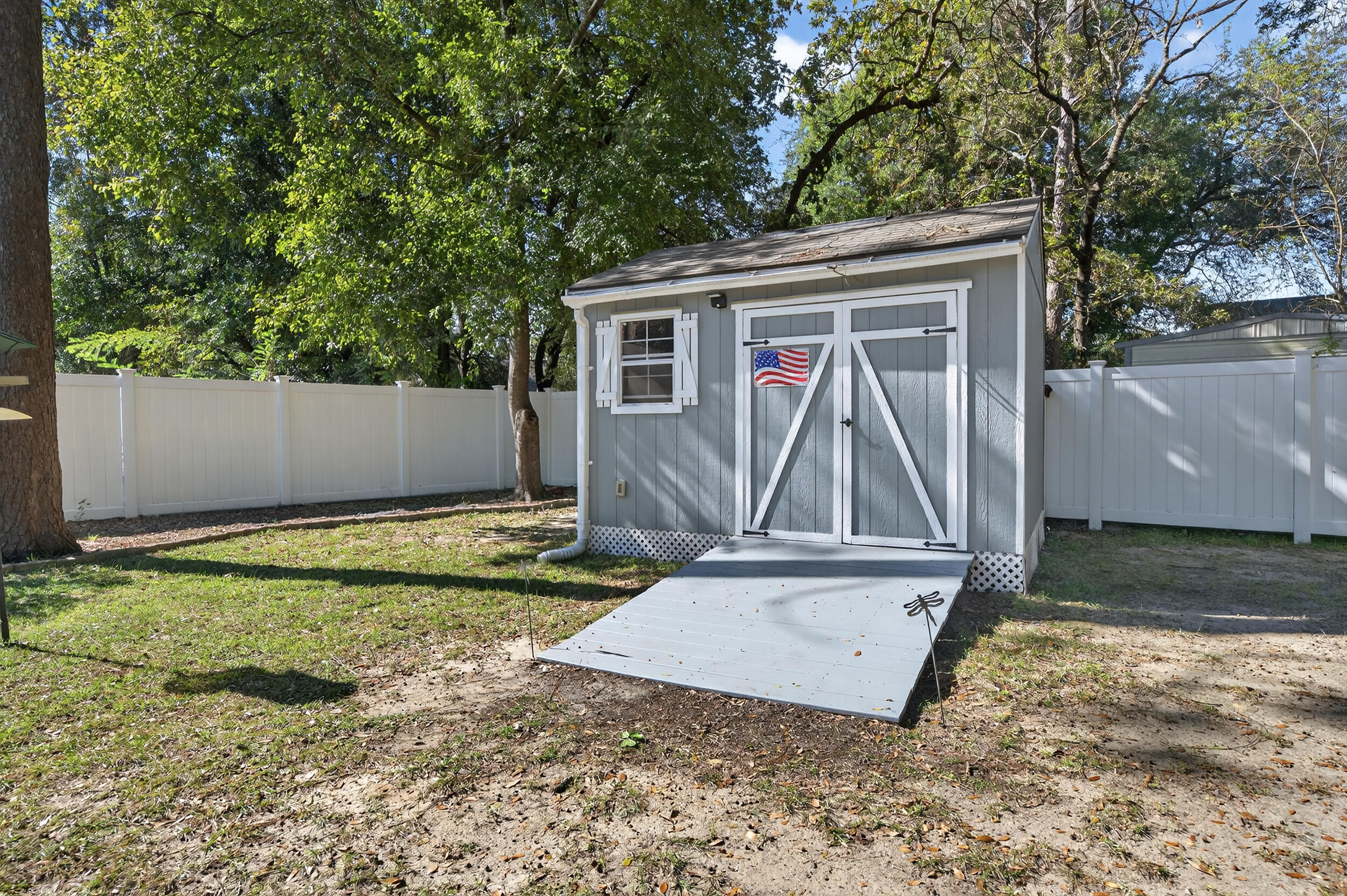 105 Cedar Point Road Crestview, FL 32539 - Photo 50 of 53 a view of a backyard with a small cabin