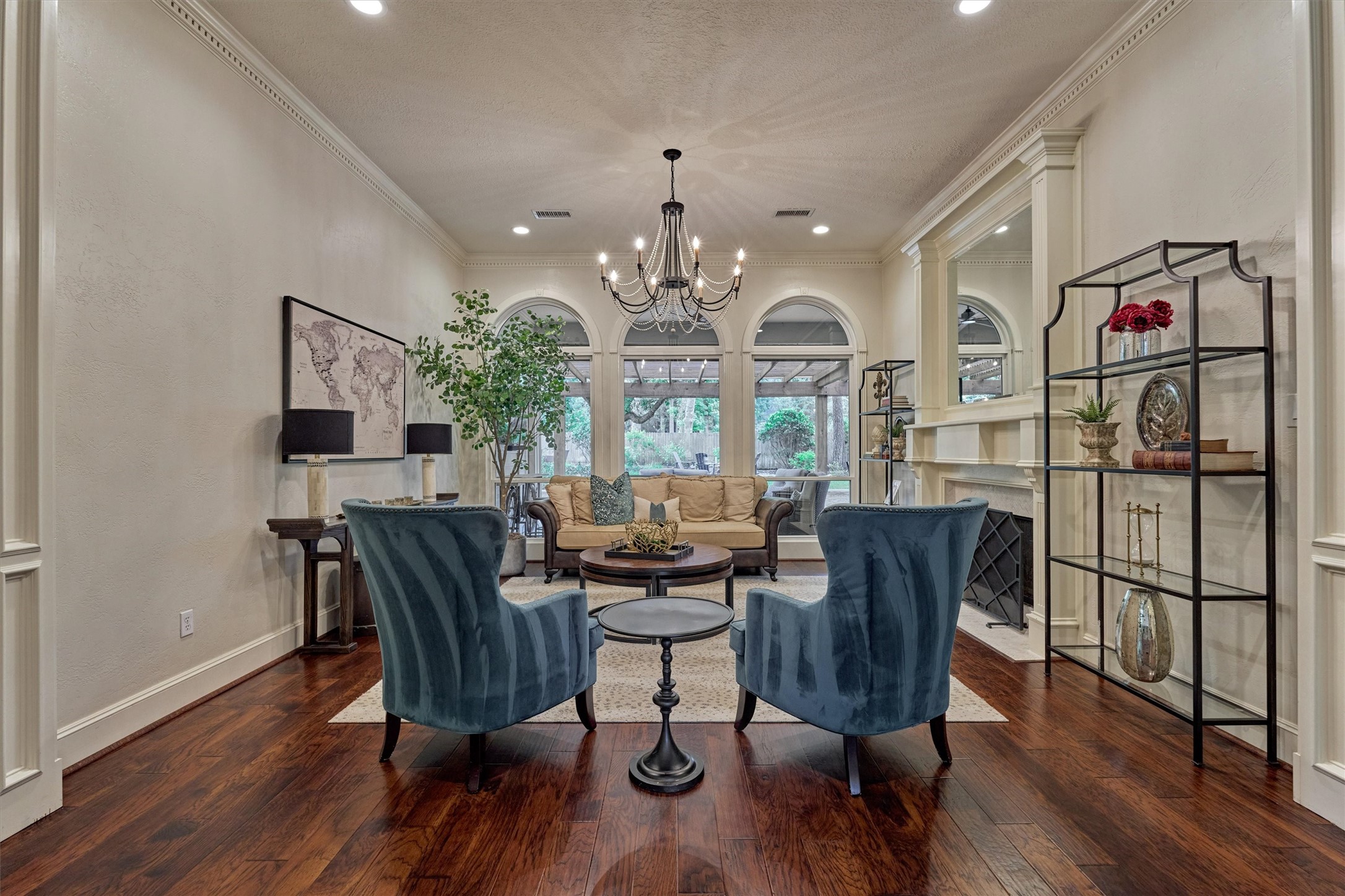 18 Treevine Court The Woodlands, TX 77381 - Photo 8 of 50 Allow your senses to be carried away with timeless beauty in this versatile living room with soaring views through transom-arched and upgraded windows towards a backyard retreat that is beyond special - a rare find!