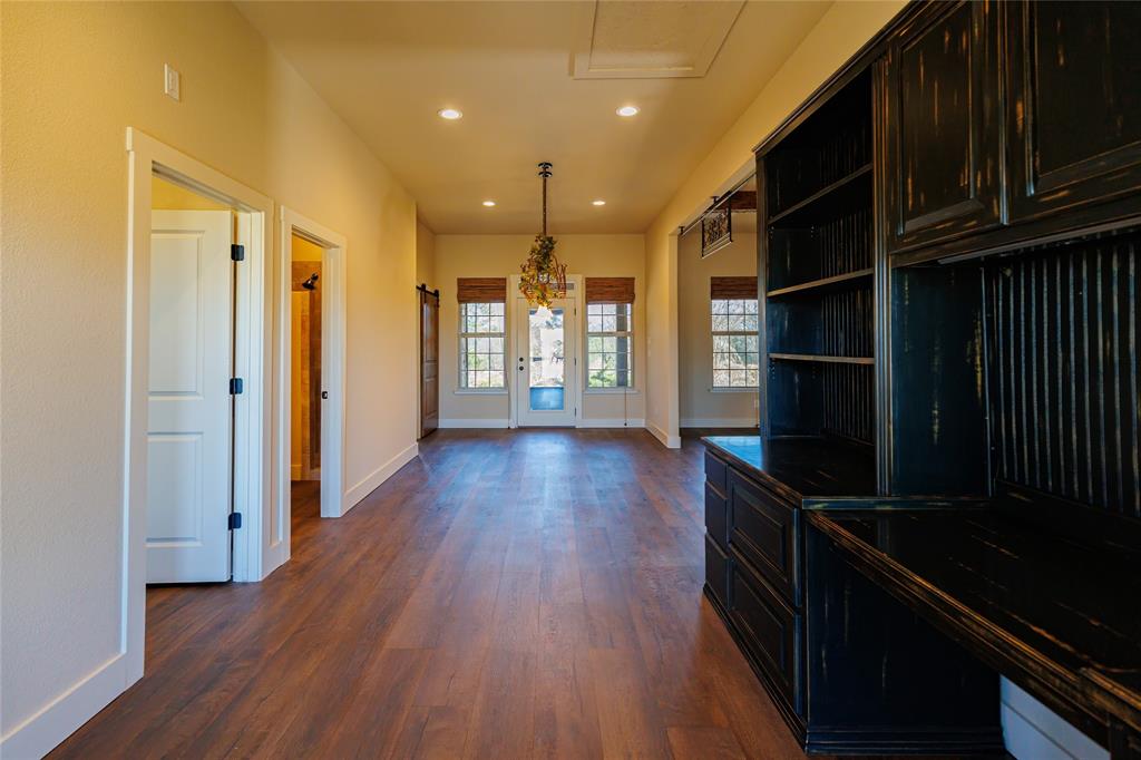 1433 County Road 1180 Decatur, TX 76234 - Photo 11 of 36 a view of a hallway with wooden floor and staircase
