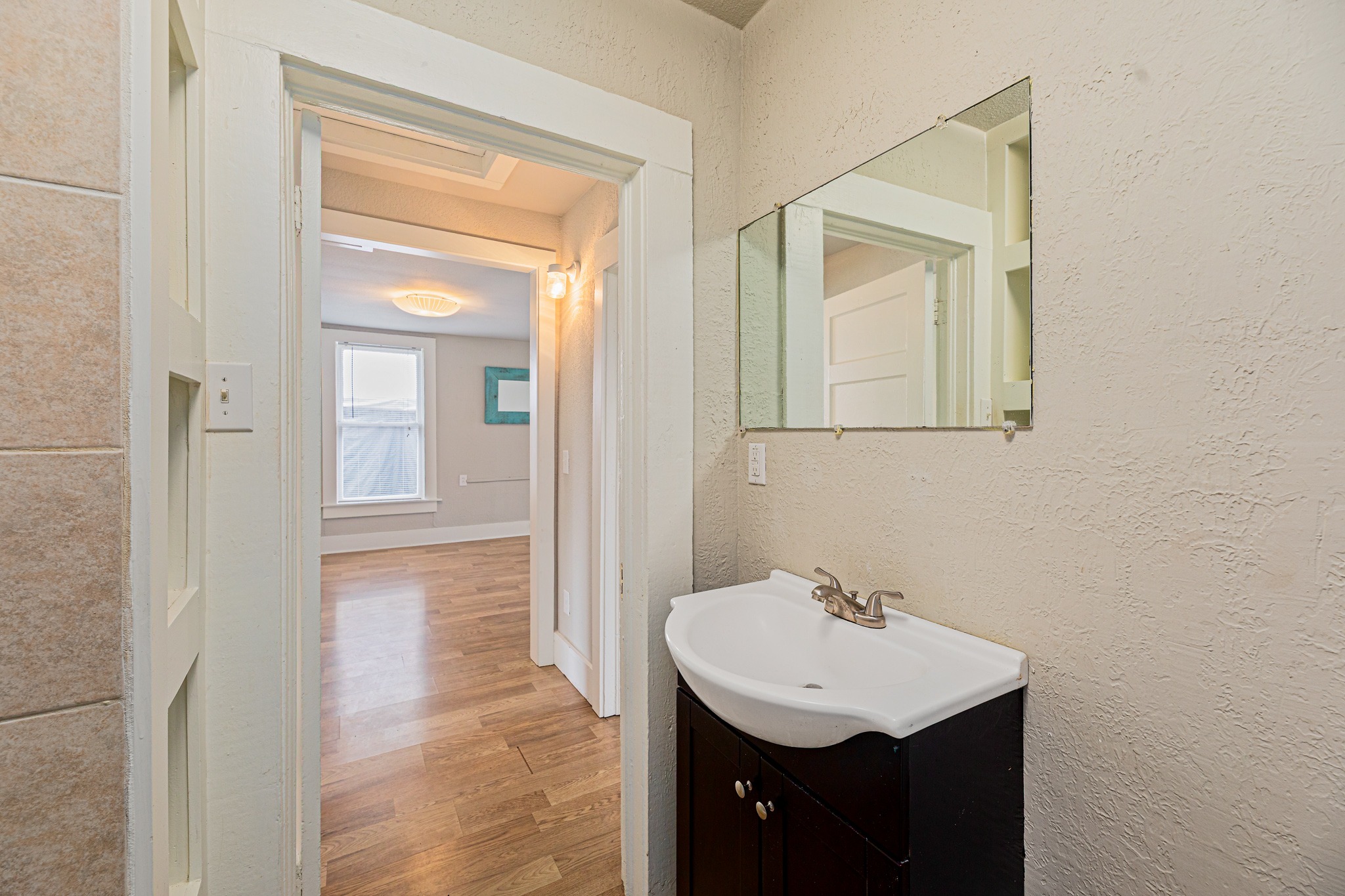 322 Blanco Avenue Luling, TX 78648 - Photo 12 of 20 A well-lit bathroom vanity area provides practical utility.