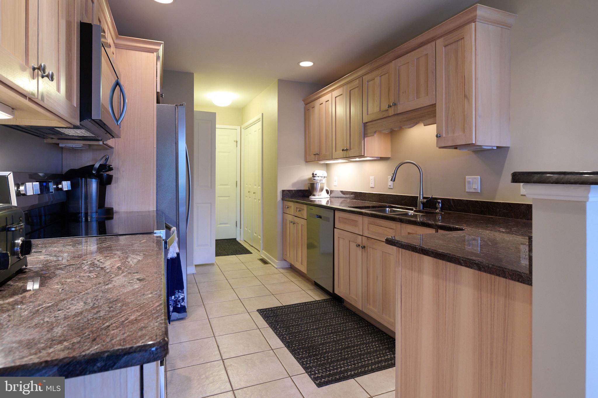 3296 Shellers Bend, Unit 144 State College, PA 16801 - Photo 14 of 48 a kitchen with stainless steel appliances granite countertop a sink stove and cabinets