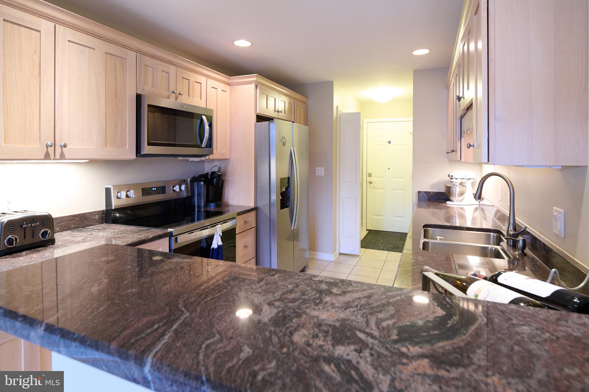 3296 Shellers Bend, Unit 144 State College, PA 16801 - Photo 15 of 48 a kitchen with stainless steel appliances granite countertop a sink stove and refrigerator