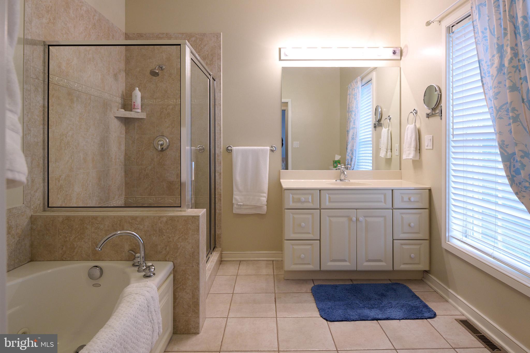 3296 Shellers Bend, Unit 144 State College, PA 16801 - Photo 26 of 48 a bathroom with a tub sink and mirror