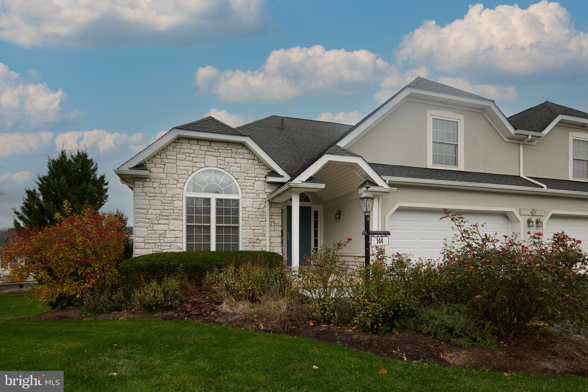 3296 Shellers Bend, Unit 144 State College, PA 16801 - Photo 3 of 48 a view of a house with brick walls and a yard with plants