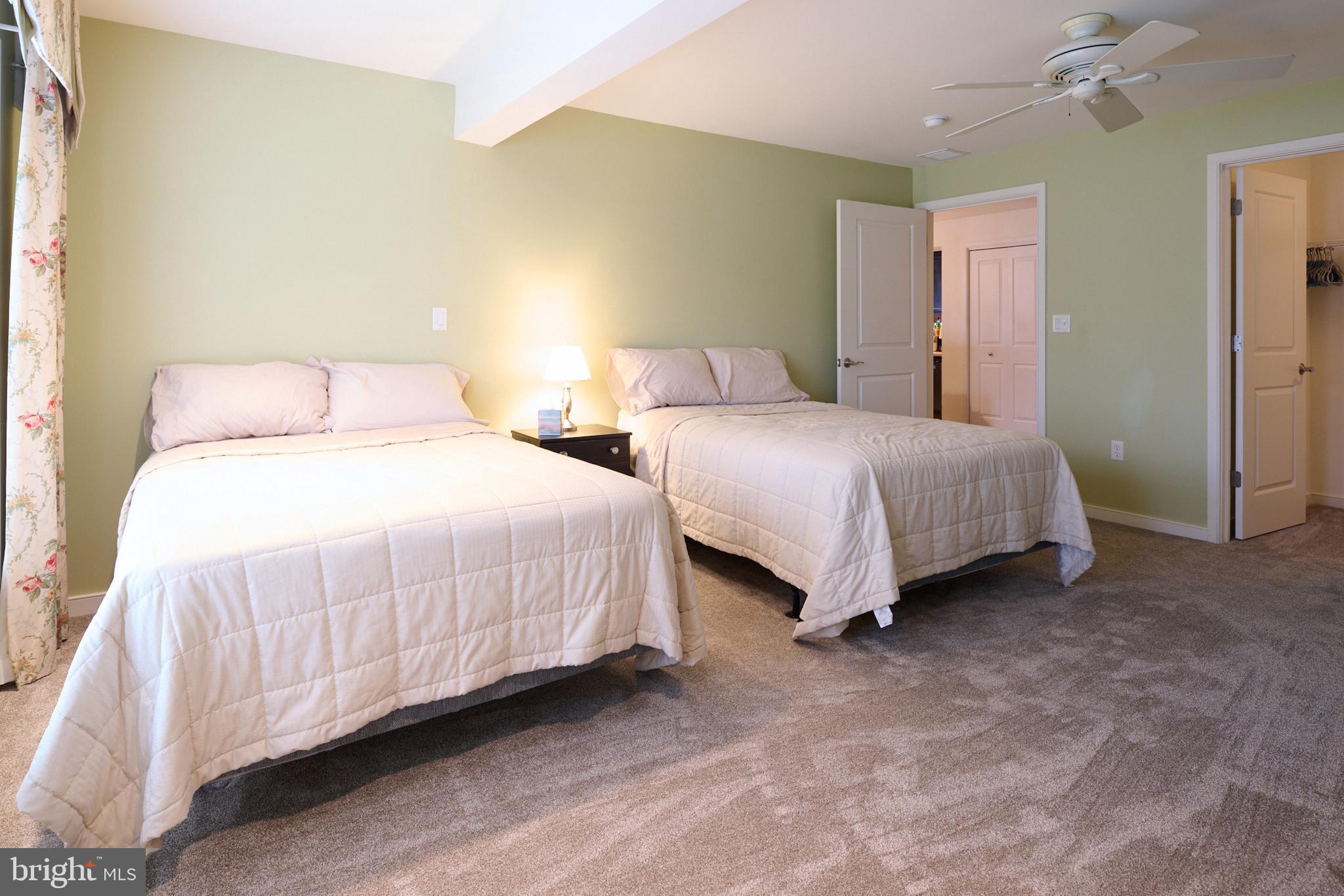 3296 Shellers Bend, Unit 144 State College, PA 16801 - Photo 37 of 48 a bedroom with two beds and painting on the wall