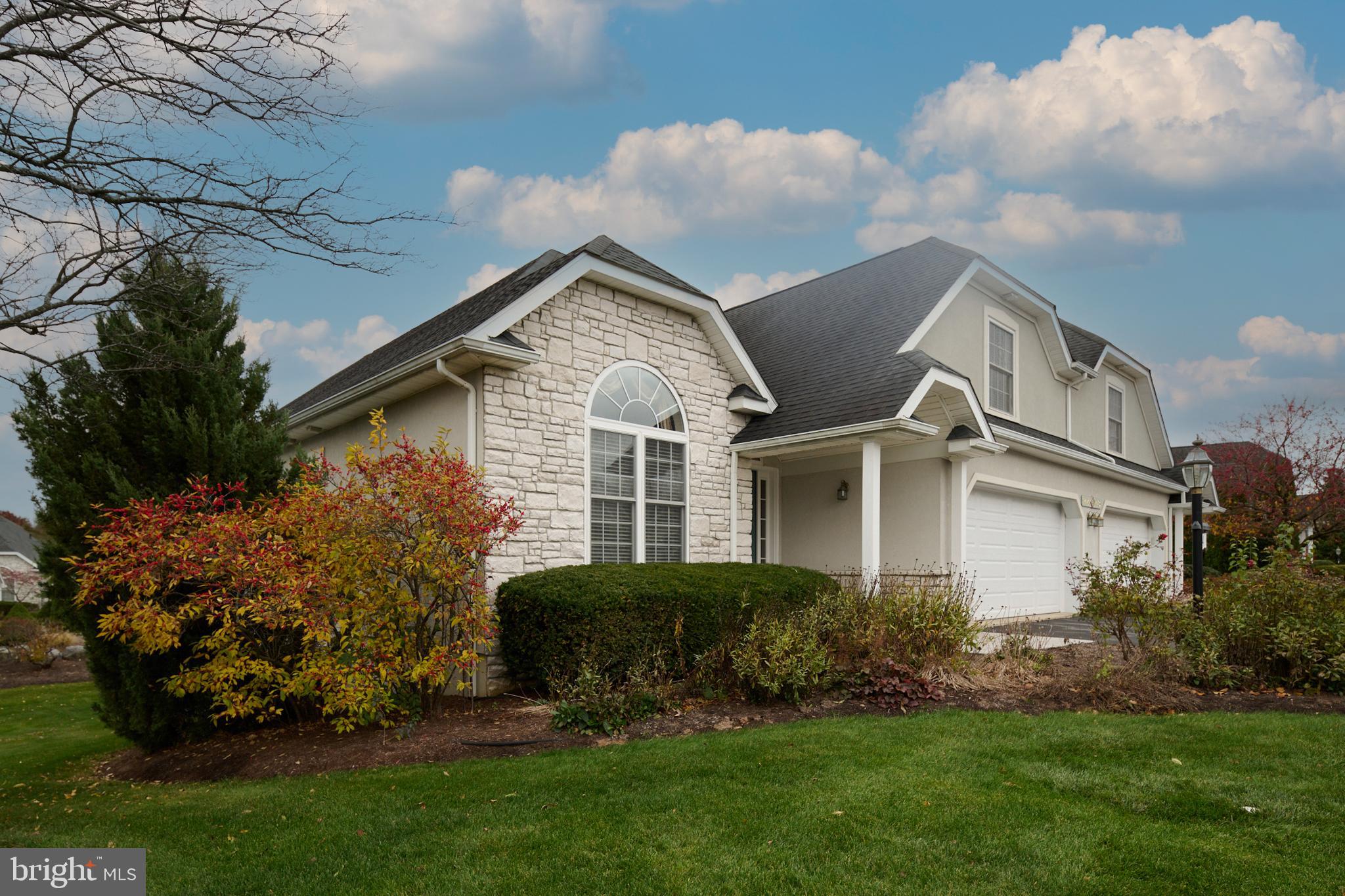 3296 Shellers Bend, Unit 144 State College, PA 16801 - Photo 4 of 48 a front view of a house with a garden