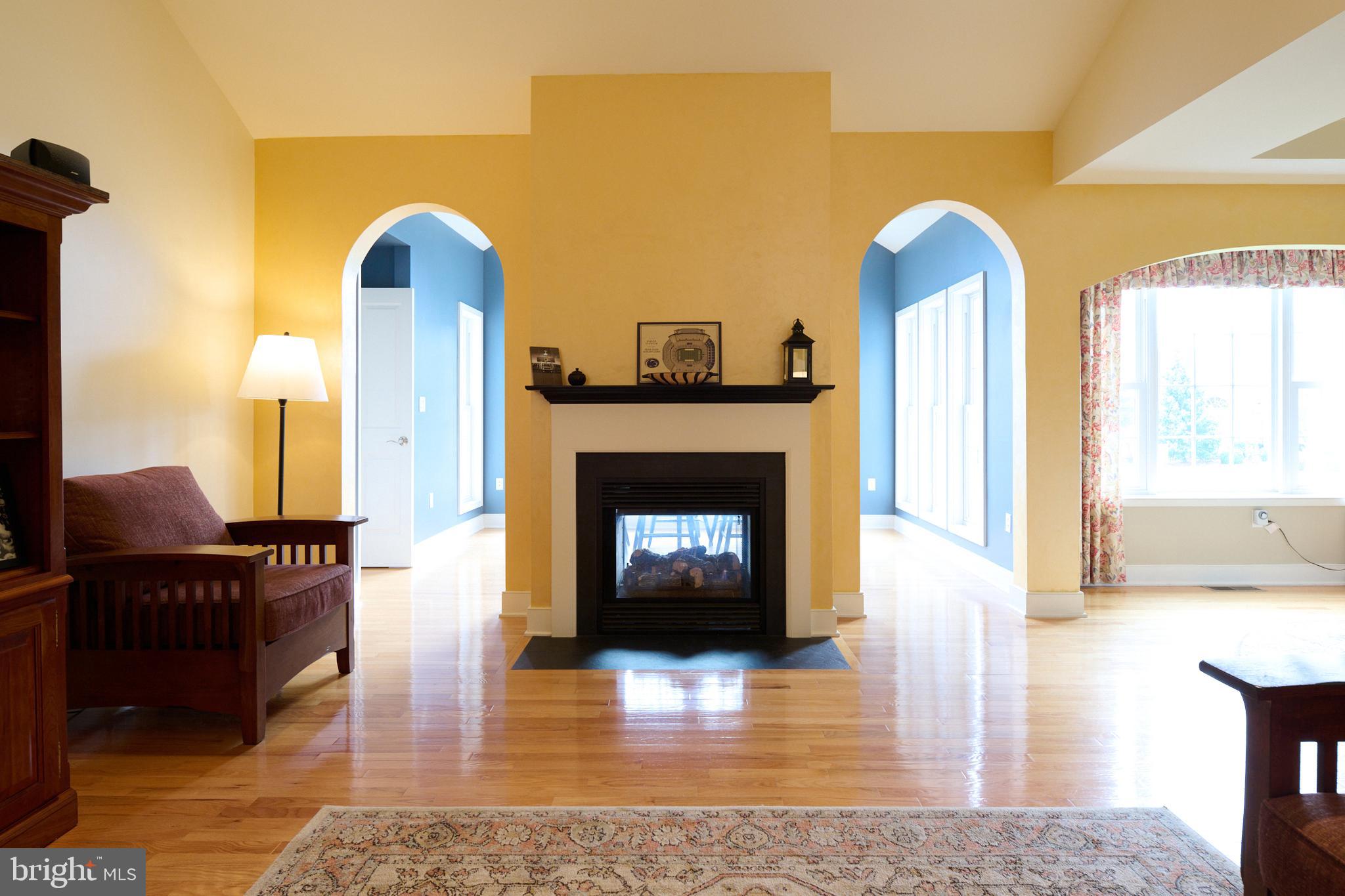 3296 Shellers Bend, Unit 144 State College, PA 16801 - Photo 8 of 48 a living room with furniture and a fireplace