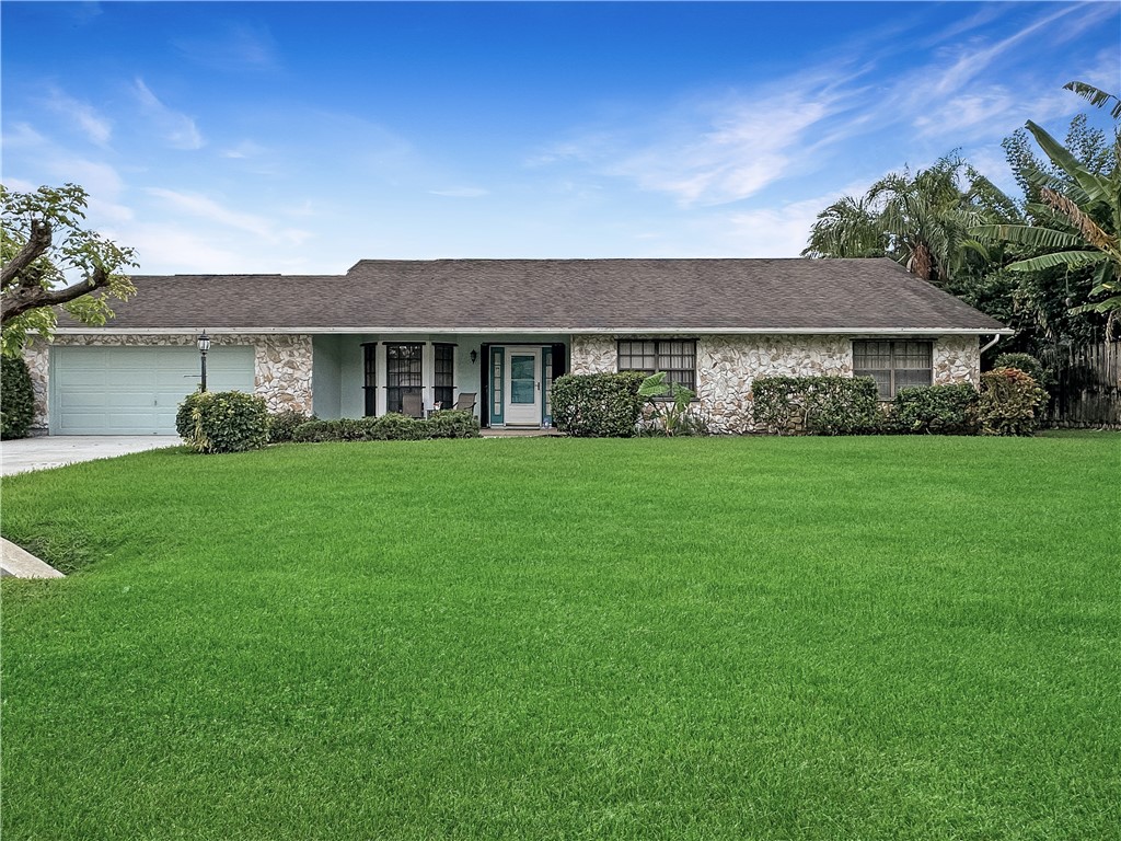 5408 Eagle Drive Fort Pierce, FL 34951 - Photo 1 of 35 a front view of house with yard and green space