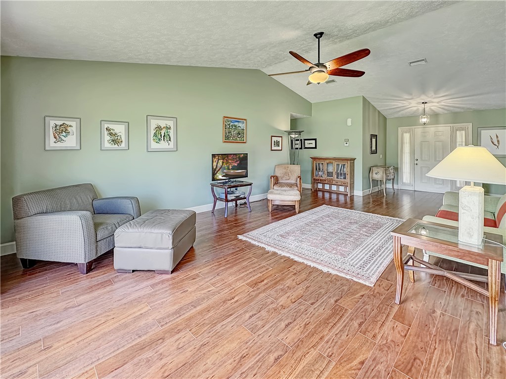 5408 Eagle Drive Fort Pierce, FL 34951 - Photo 12 of 35 a living room with furniture and a wooden floor
