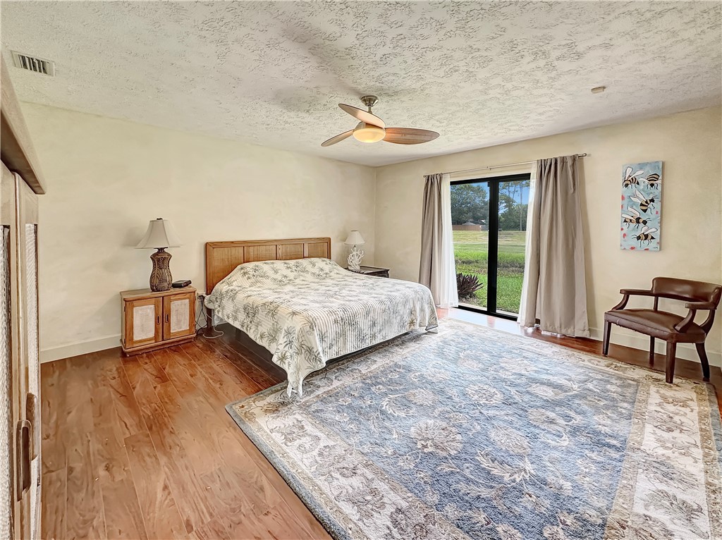 5408 Eagle Drive Fort Pierce, FL 34951 - Photo 15 of 35 a bedroom with a bed and a chandelier