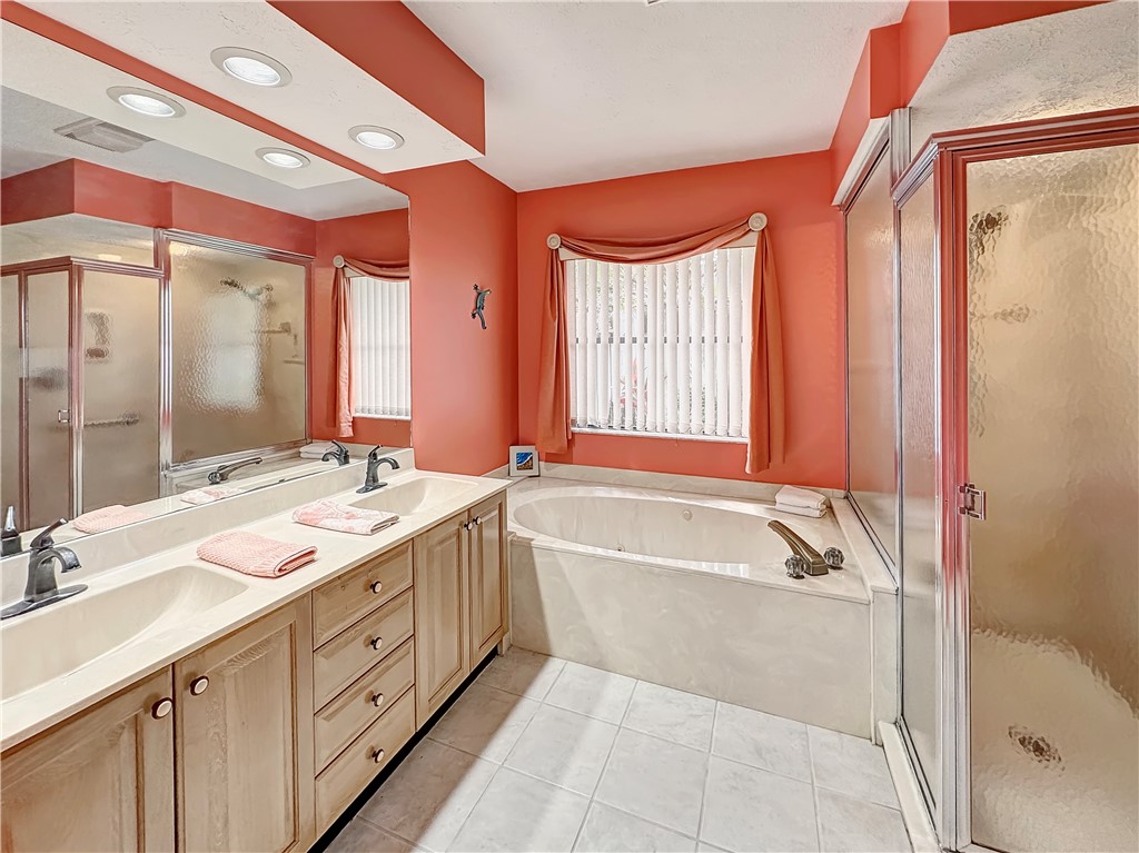 5408 Eagle Drive Fort Pierce, FL 34951 - Photo 20 of 35 a bathroom with a tub sink shower and mirror