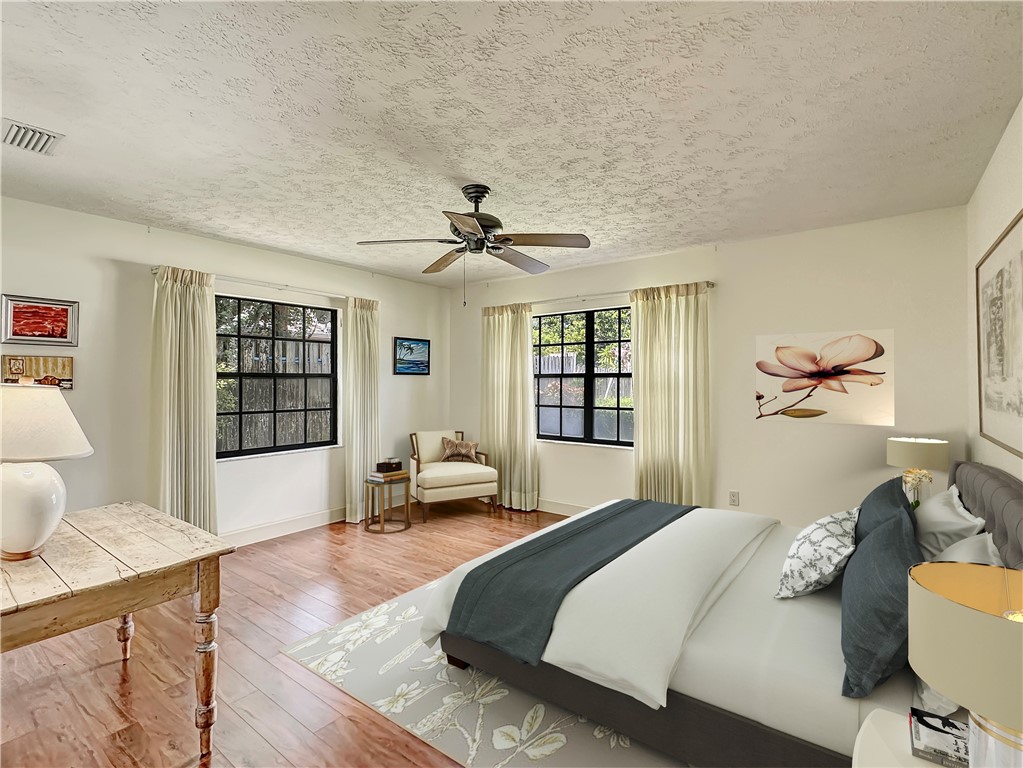 5408 Eagle Drive Fort Pierce, FL 34951 - Photo 25 of 35 a bedroom with a bed and wooden floor
