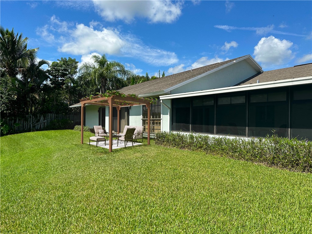 5408 Eagle Drive Fort Pierce, FL 34951 - Photo 34 of 35 a view of a house with backyard sitting area and garden