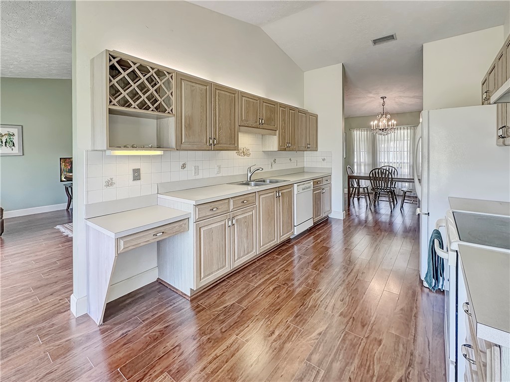 5408 Eagle Drive Fort Pierce, FL 34951 - Photo 5 of 35 a kitchen with a sink stove and cabinets