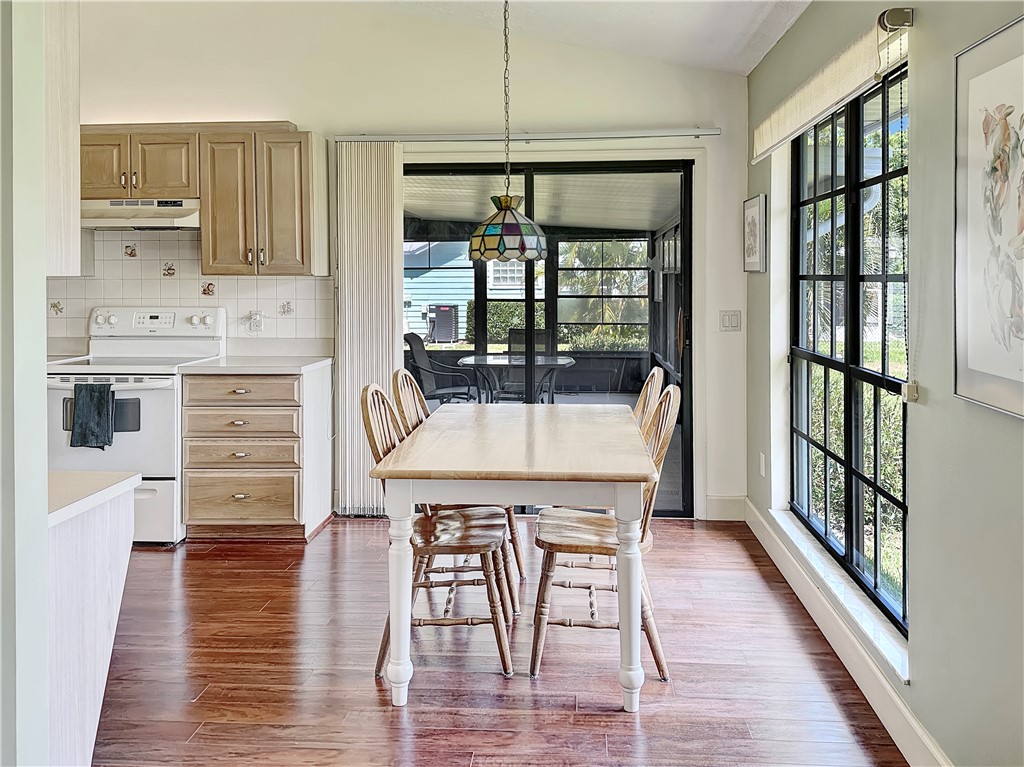 5408 Eagle Drive Fort Pierce, FL 34951 - Photo 6 of 35 a kitchen with a table chairs refrigerator and cabinets