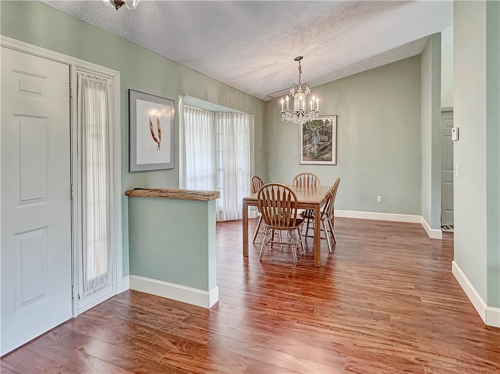 5408 Eagle Drive Fort Pierce, FL 34951 - Photo 7 of 35 a view of a dining room with furniture window and wooden floor