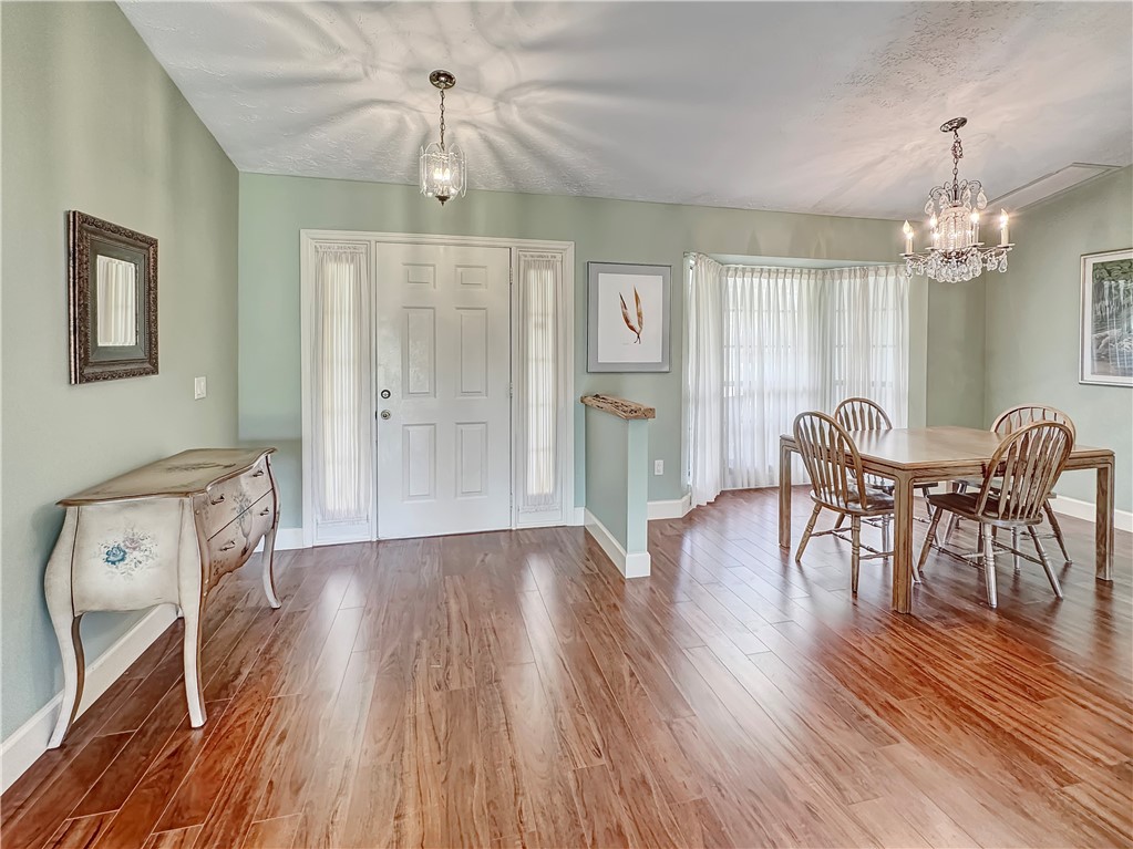 5408 Eagle Drive Fort Pierce, FL 34951 - Photo 8 of 35 a view of a dining room with furniture window and wooden floor